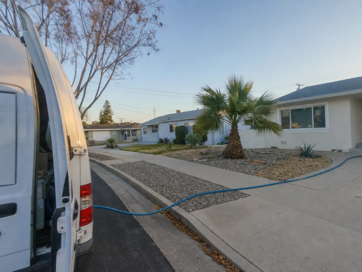 Service van arriving on a Tarzana, CA street — local same-day coverage